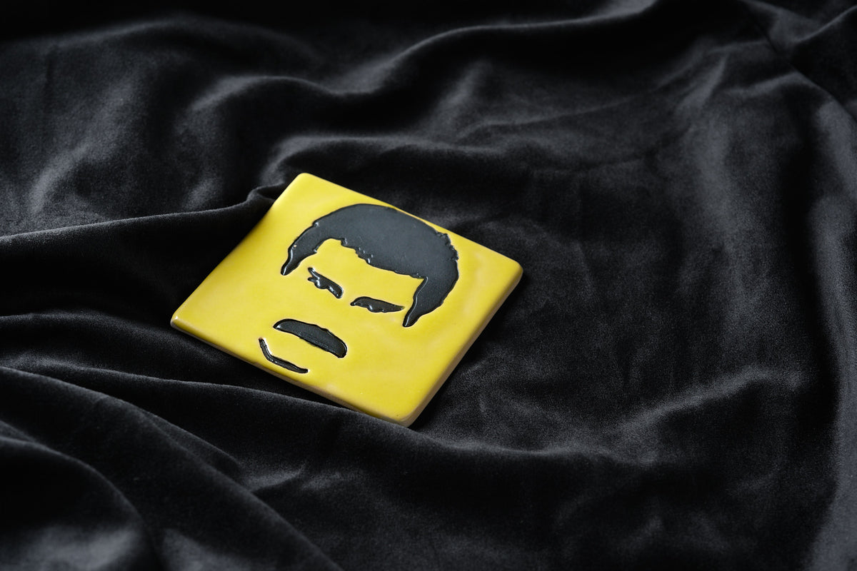 Close-up of the hand-painted Freddie motif on the tile