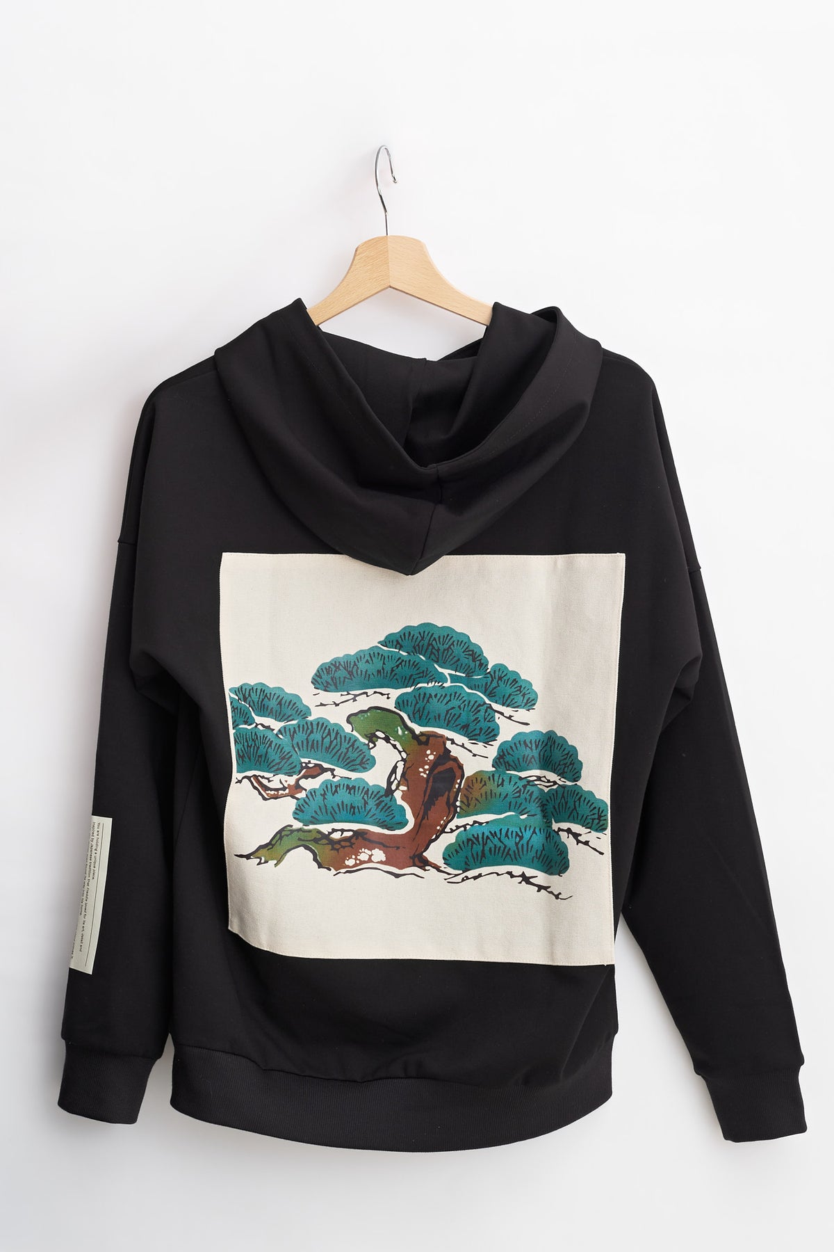 Tree Edition Hoodie on a hanger, back view