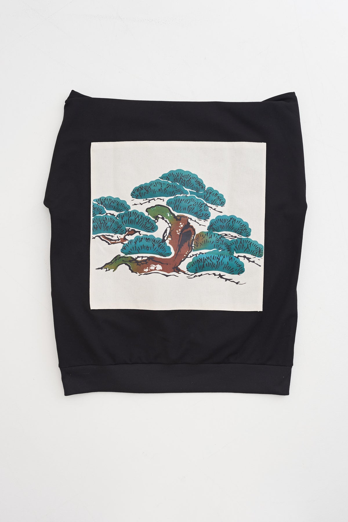 Tree Edition Hoodie folded, pine print detail